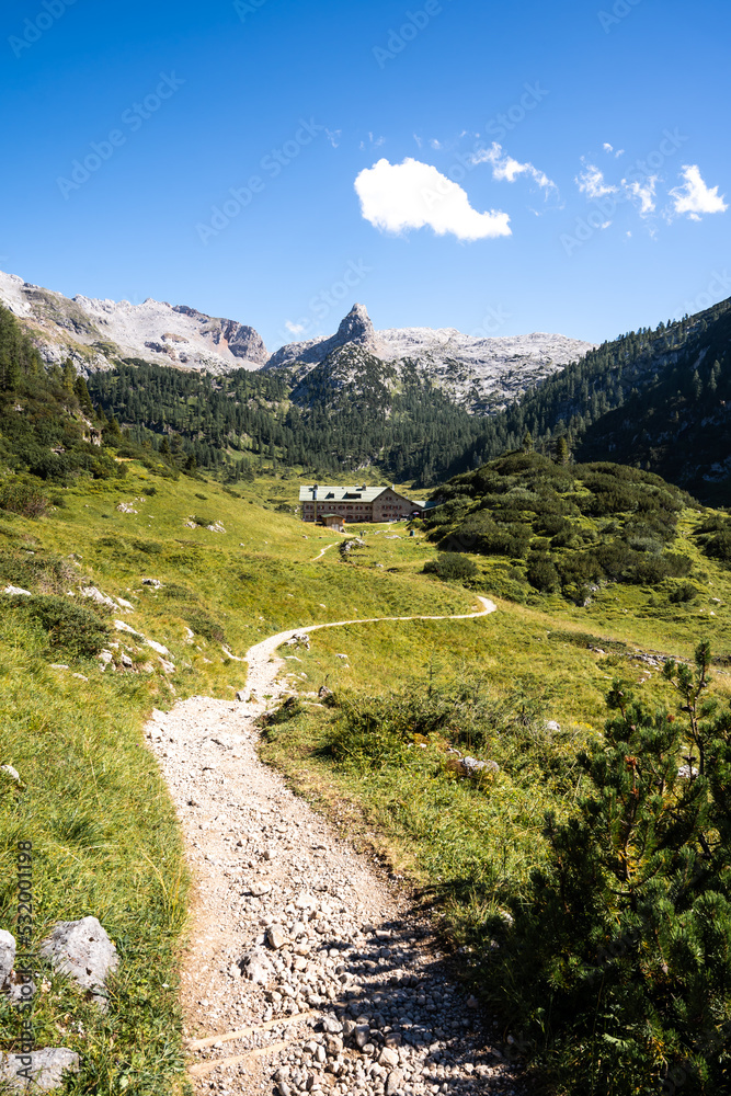 Path leading hikers to a mountain hut in the Alps