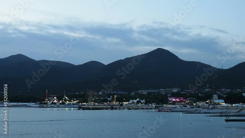 amusement park lights up in the evening on the coast of the seaside resort