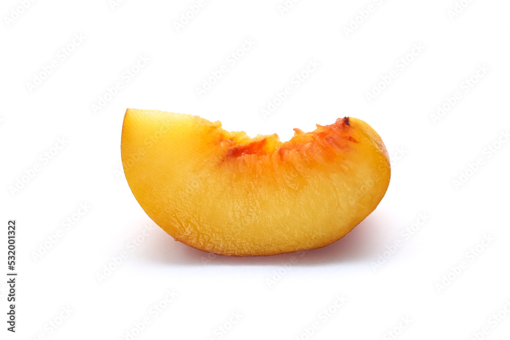 A slice of peach on a white background. Close-up