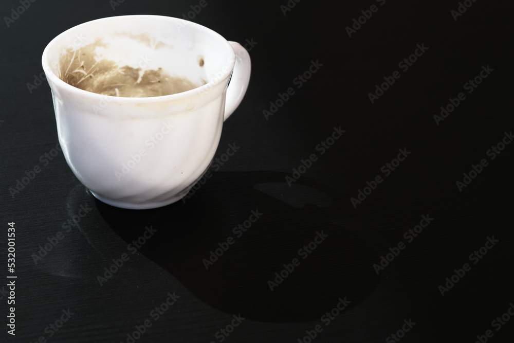 Empty little glass cup from coffee with milk, dirty used small ceramic mug from cappuccino, white finished tiny bowl from expresso isolated on the black tabletop, nobody cafe dishware, closeup, art. Empty little glass cup from coffee with milk, dirty used small ceramic mug from cappuccino, white finished tiny bowl from expresso isolated on the black tabletop, nobody cafe dishware, closeup, art.