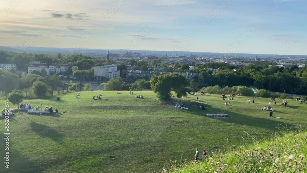 aerial view of city and green park on summer at sunset on hills in poland 