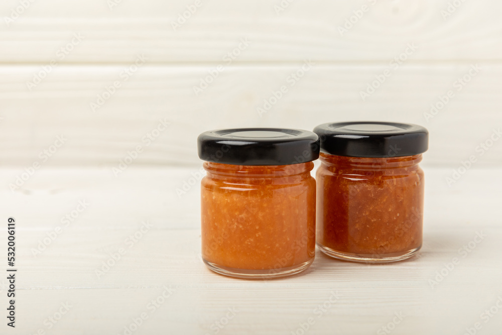 Nut honey jar on white wood. Cold medicine. Useful fortified product with almonds, pistachios, star anise and cinnamon for health and beauty. Vegetarian diet organic product. Copy space.place for text Nut honey jar on white wood. Cold medicine. Useful fortified product with almonds, pistachios, star anise and cinnamon for health and beauty. Vegetarian diet organic product. Copy space.place for text