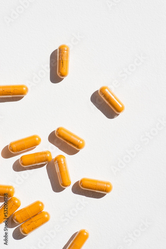 Turmeric plus black pepper extract gelatin capsule close up top view. Herbal supplement organic curcumin. Supports antioxidant health
