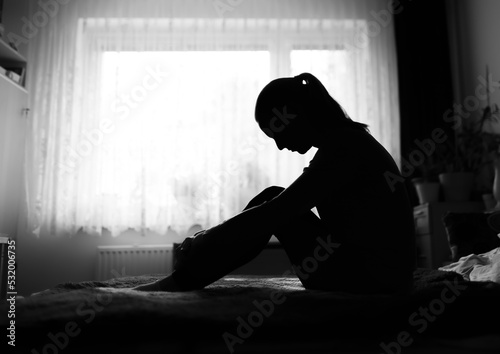 Obraz na plátně Silhouette of unhappy woman at home suffering rom depression, sadness, divorce, loneliness