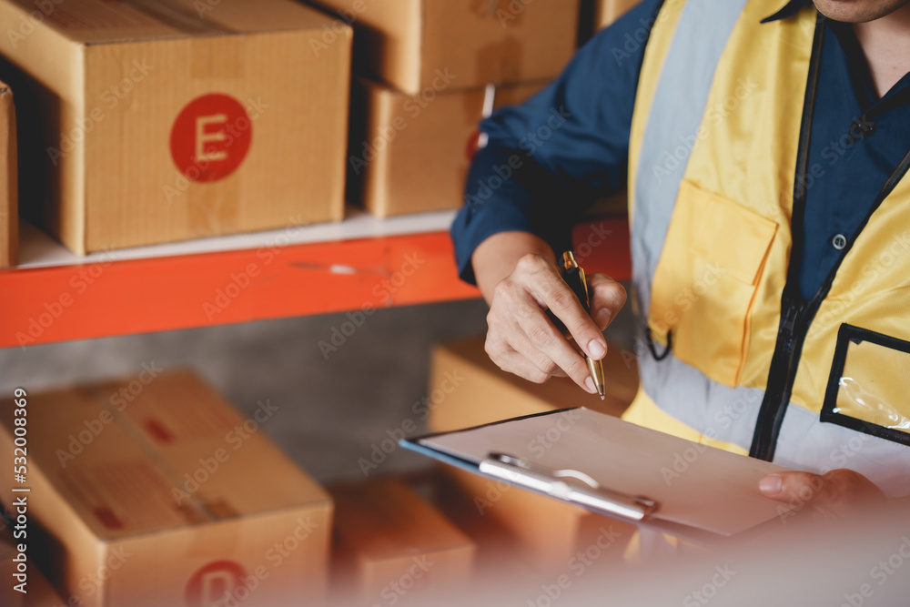 Male warehouse check worker checking and counting inventory accurately