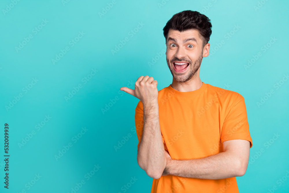 Photo of young handsome bearded funny positive guy smile excited finger pointing empty space advertisement crazy isolated on aquamarine color background Photo of young handsome bearded funny positive guy smile excited finger pointing empty space advertisement crazy isolated on aquamarine color background