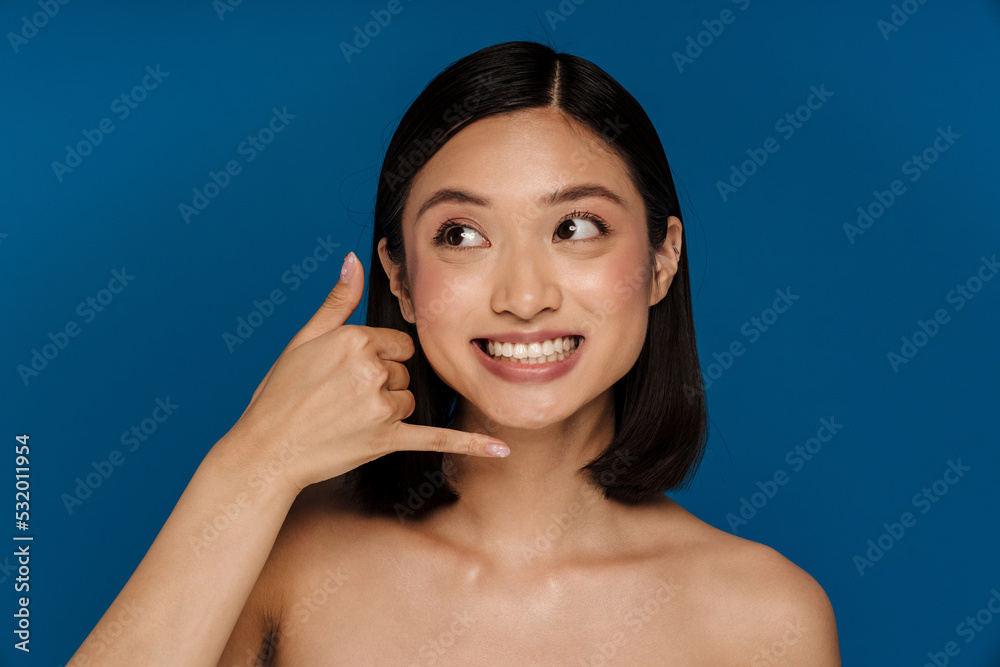Young beautiful happy smiling asian woman doing phone gesture Young beautiful happy smiling asian woman doing phone gesture