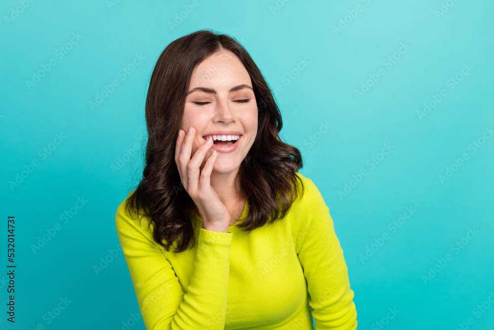 Photo of young pretty cute nice perfect woman laugh reaction joke empty space new show comic isolated on cyan color background Photo of young pretty cute nice perfect woman laugh reaction joke empty space new show comic isolated on cyan color background