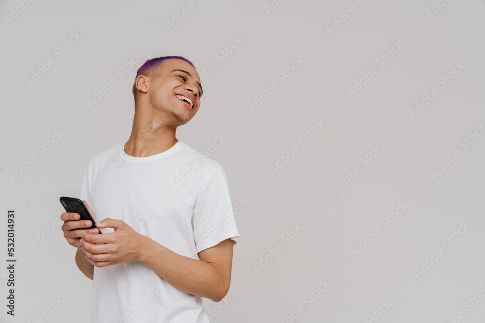 Portrait of young handsome boy holding phone and looking behind Portrait of young handsome boy holding phone and looking behind