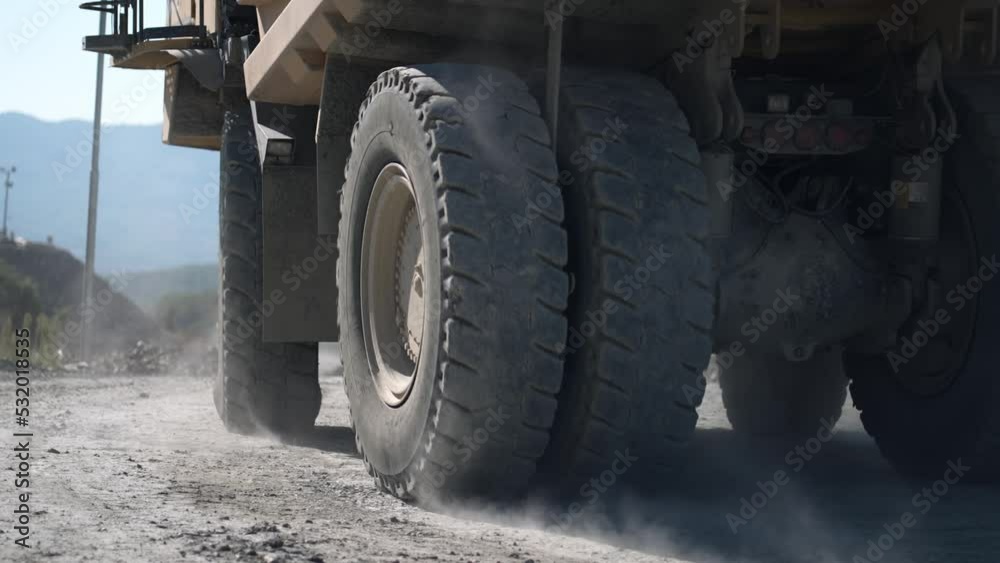 Heavy mining truck on the iron ore opencast mining quarry, industrial exterior, ore mining quarry on sunny day, summer, slow motion Heavy mining truck on the iron ore opencast mining quarry, industrial exterior, ore mining quarry on sunny day, summer, slow motion