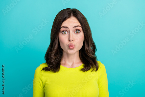 Photo of lovely brunette hair millennial lady blow kiss wear green shirt isolated on teal color background