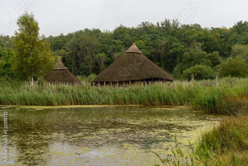 view of a typical Crannog or artificial island in a lake in the Irish National Heritage Park