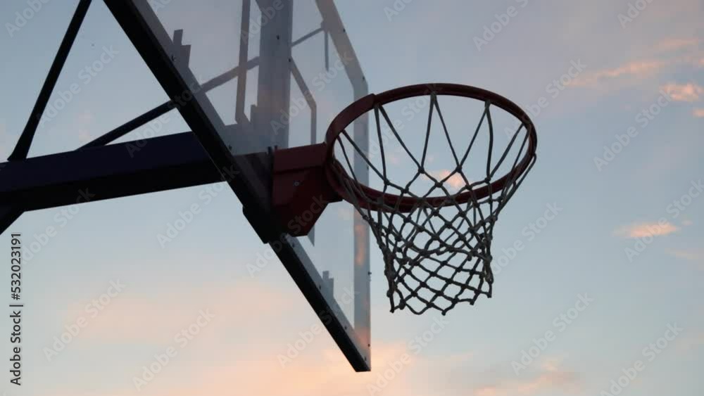 4k video Silhouettes of basketball players at the beautiful sunset. Amazing cinematic sport shoot. Two male playing street ball outside. 4k video Silhouettes of basketball players at the beautiful sunset. Amazing cinematic sport shoot. Two male playing street ball outside.