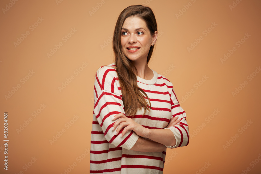 Smiling woman in casual clothes with arms crossed looking back over shoulder. Isolated female portrait. Smiling woman in casual clothes with arms crossed looking back over shoulder. Isolated female portrait.