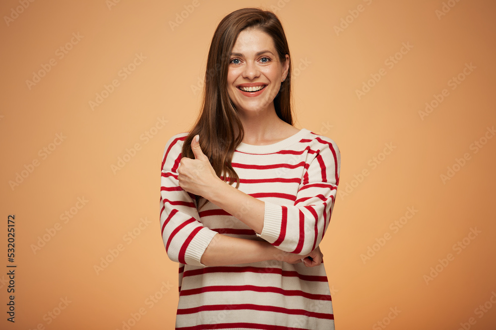 Smiling woman in casual clothes shows thumb up. Isolated female portrait. Smiling woman in casual clothes shows thumb up. Isolated female portrait.