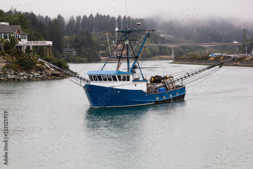 A fishing boat going out to sea in Brookings, Oregon photo