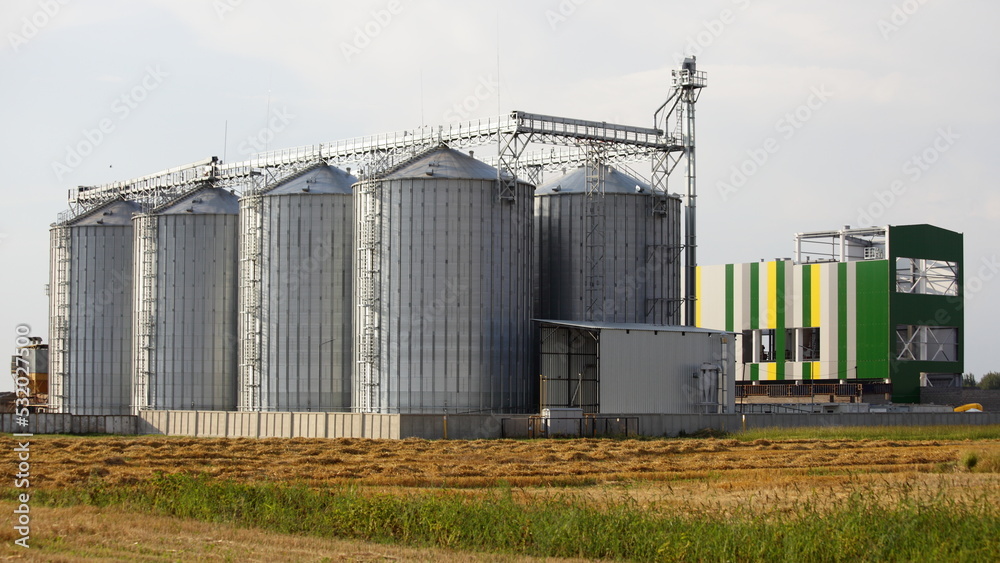 Modern cereal dryer tanks on the farm . Agricultural business investments Modern cereal dryer tanks on the farm . Agricultural business investments
