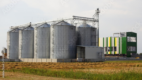 Modern cereal dryer tanks on the farm . Agricultural business investments
