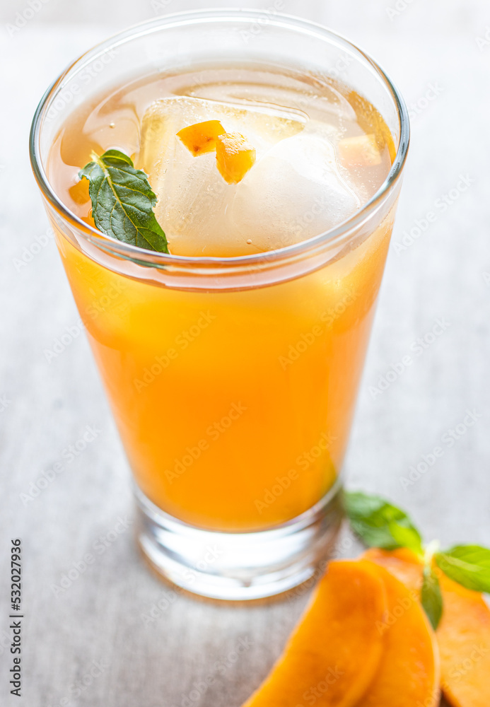 cup of tea passion fruit and mango with lemon and a mint leaf. cup of tea passion fruit and mango with lemon and a mint leaf.