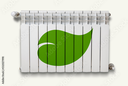 White heater with a painted green leaf against a white wall