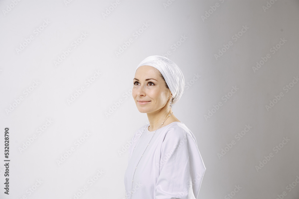 Portrait of a girl in a hijab in white clothes against a white background Portrait of a girl in a hijab in white clothes against a white background