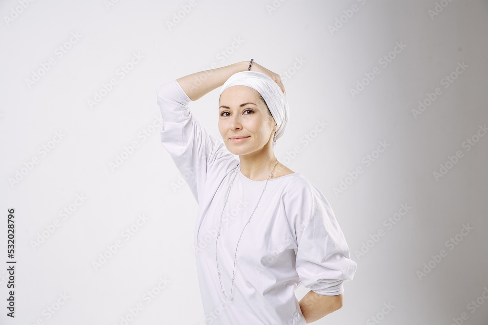 Portrait of a girl in a hijab in white clothes against a white background Portrait of a girl in a hijab in white clothes against a white background