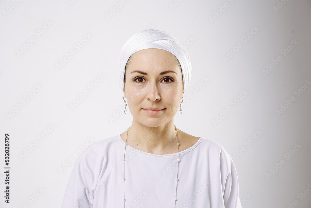 Portrait of a girl in a hijab in white clothes against a white background Portrait of a girl in a hijab in white clothes against a white background