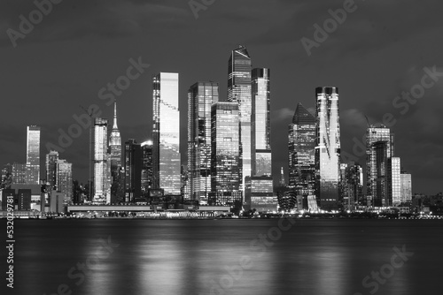 Manhattan midtown skyline, seen from across the Hudson River at night. Beautiful reflections and light. High quality photo