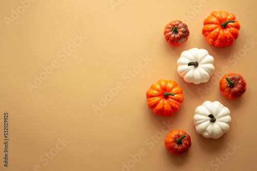 Fall autumn flat lay background. White and orange pumpkins at color layout. Autumn decorations with copy space.