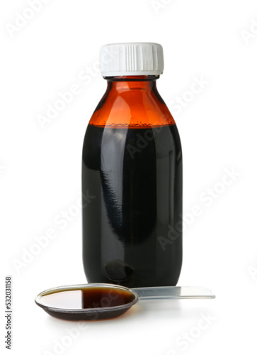 Bottle of cough syrup and spoon on white background