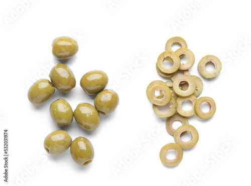 Whole and cut green olives on white background