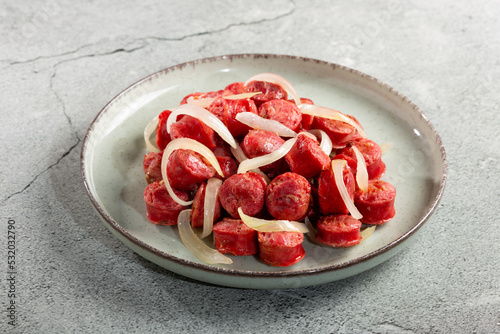 Portion of sausage with onion.