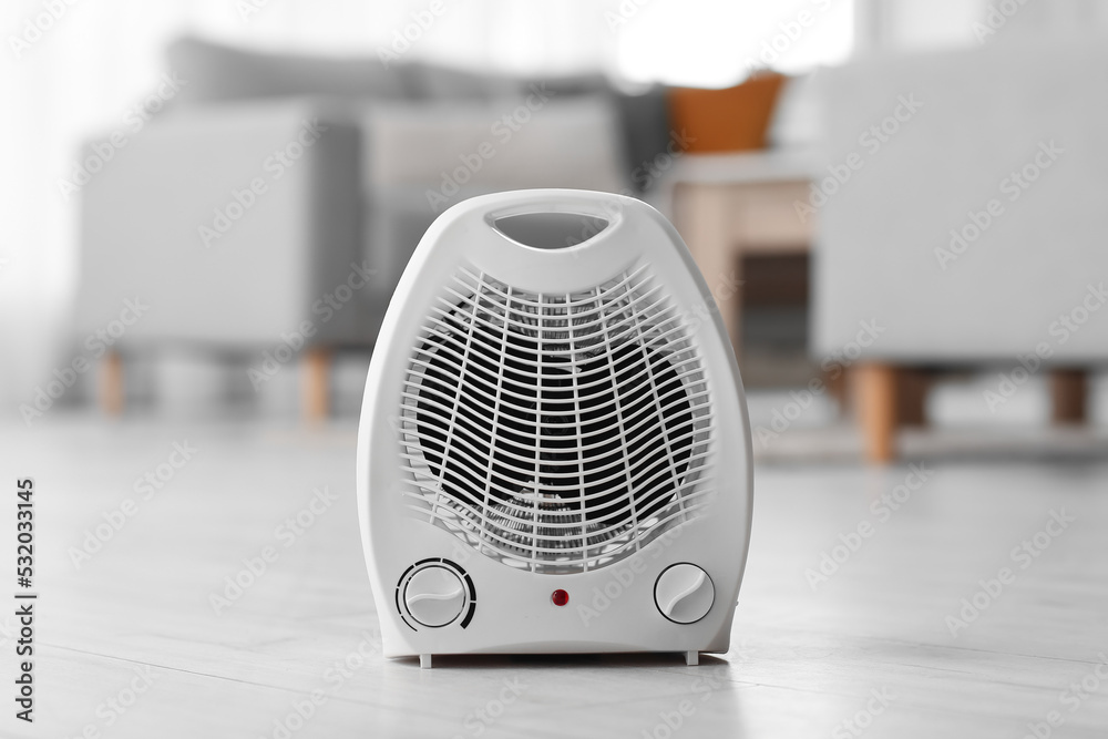Electric fan heater on floor in living room Electric fan heater on floor in living room