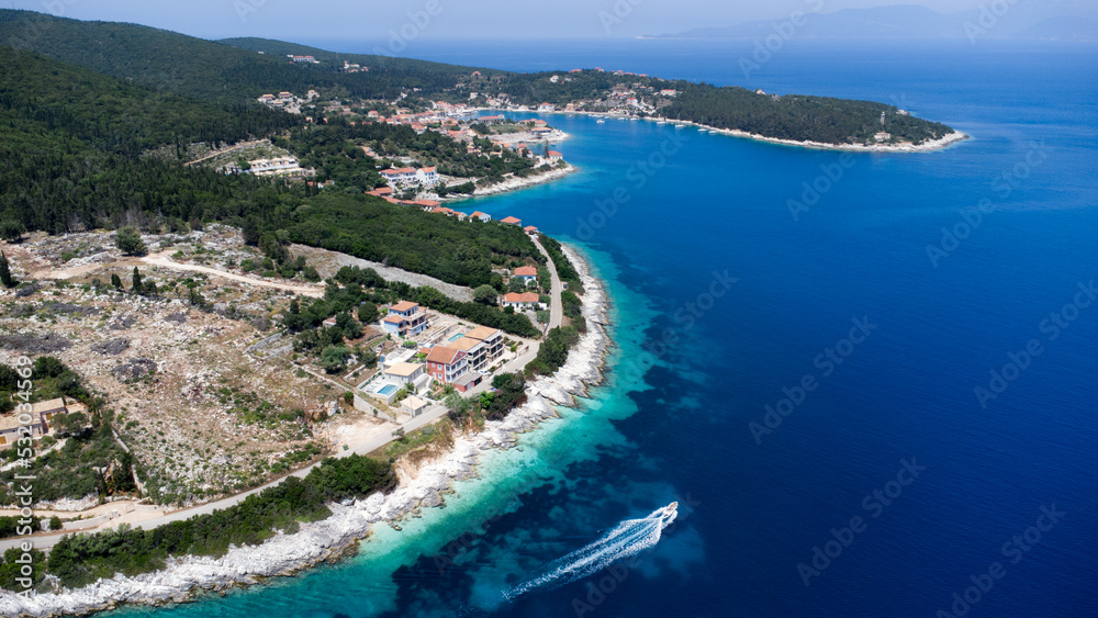 Drone view to boat in crystal pacific blue sea in Greece, on idyllic greek island in Ionian sea