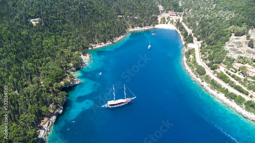 Drone view to lagoon and sailing yahct on idyllic beautiful greek island with crystal blue water