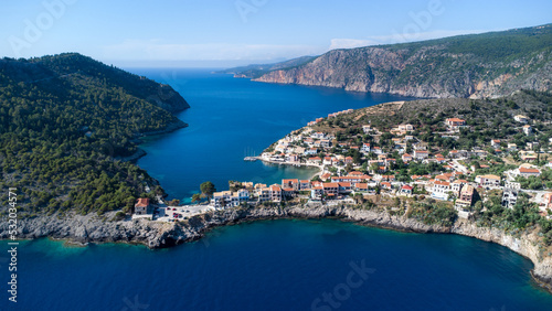 Drone view to beautiful remote village in Greece, surrounded by crystal pacific blue and impressive cliffs on idyllic greek island in Ionian sea
