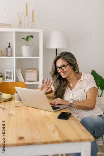 Happy woman having online video meeting from home