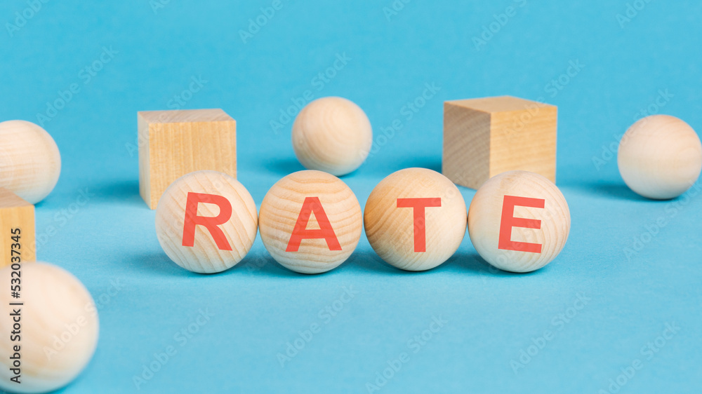 rate - text on wooden block with bright blue background rate - text on wooden block with bright blue background