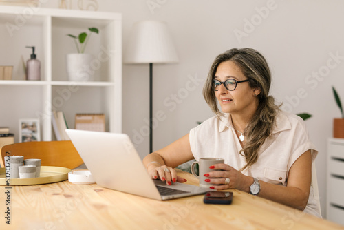 Caucasian woman working online from home © STUDIO TAURUS