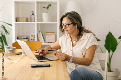 Caucasian mature woman working online from home