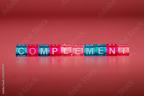 the word "complement" made up of cubes