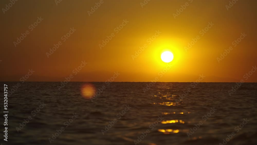 Fantastic sunset over ocean. Golden sun in the sky background and reflecting on water Fantastic sunset over ocean. Golden sun in the sky background and reflecting on water