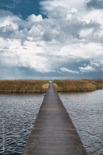 Wooden jetty over sea leading to a island in Utvalinge, Sweden. Selective focus. photo