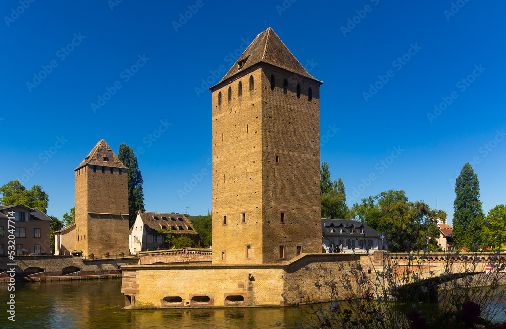 Scenic summer view from Vauban Dam of Petite France quarter, covered bridges and watchtowers on River Ill in city of Strasbourg in France..