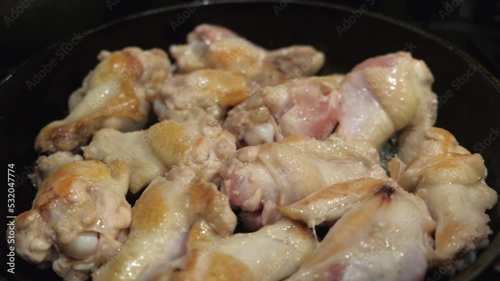 Fried chicken in a frying pan close-up. home baked chicken legs Fried chicken in a frying pan close-up. home baked chicken legs
