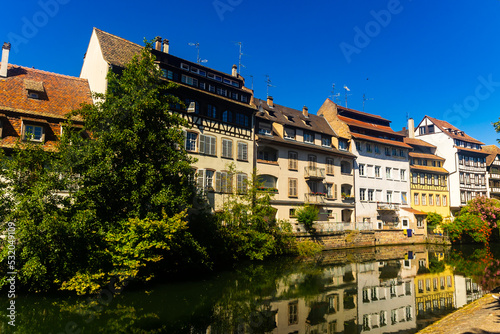 Peaceful cityscape of Strasbourg during summertime. Streets and canals of French city.