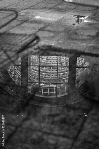 B&W puddle reflection of glass building at night - Charlotte, NC
