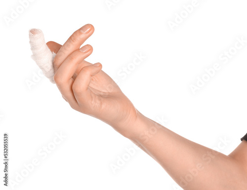 Woman with finger wrapped in medical bandage on white background, closeup