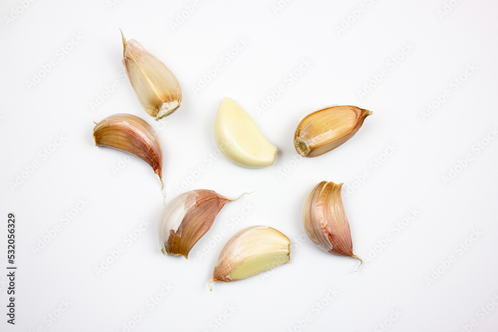 Natural garlic on a white isolated background. Heads of unprepared garlic.