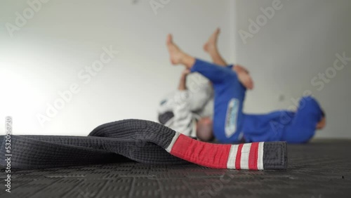 Brazilian jiu jitsu bjj black belt second degree on the tatami mats at gym or academy martial arts concept copy space selective focus photo